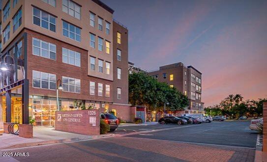 Front view of a multi-story apartment building at dusk.