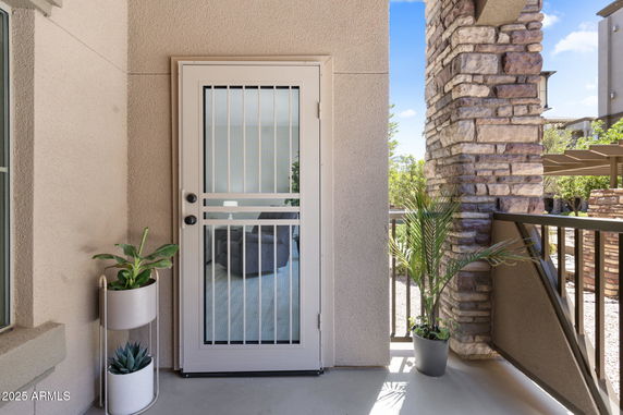Exterior view of a building entrance with a door and potted plants.