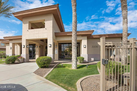 Front view of a modern building with columns and large windows.