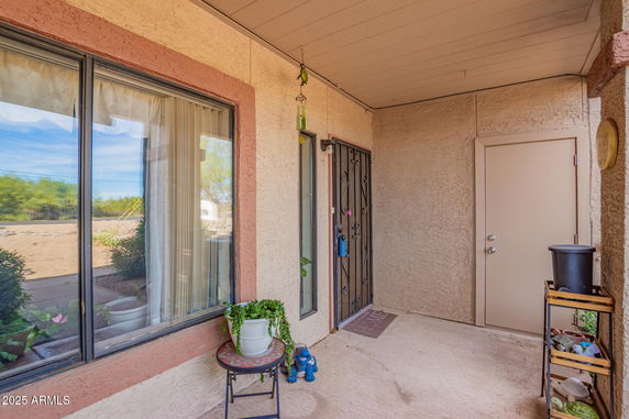 Entrance view of a house with a metal security door and adjacent window.