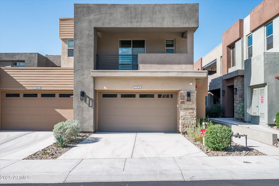 Front view of a modern two-story house with a garage.