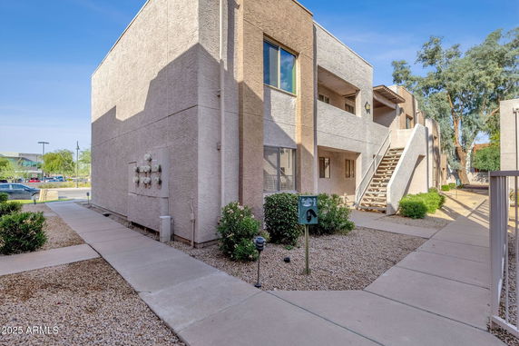 Front view of a two-story building with external staircase.