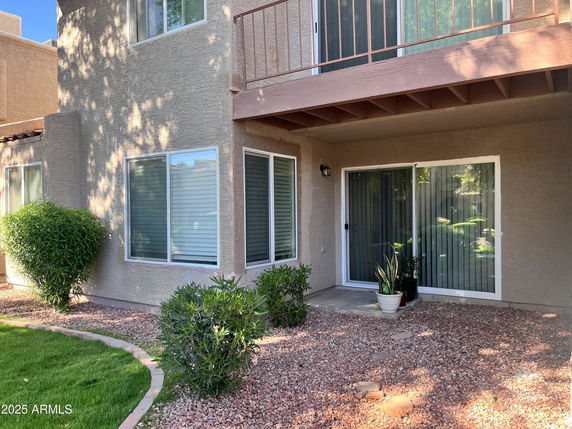 Front view of a house with corner windows and a balcony.