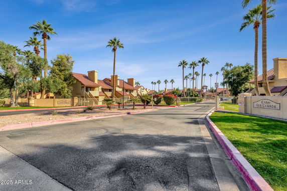 Front view of a residential complex with multiple buildings and gated entry.