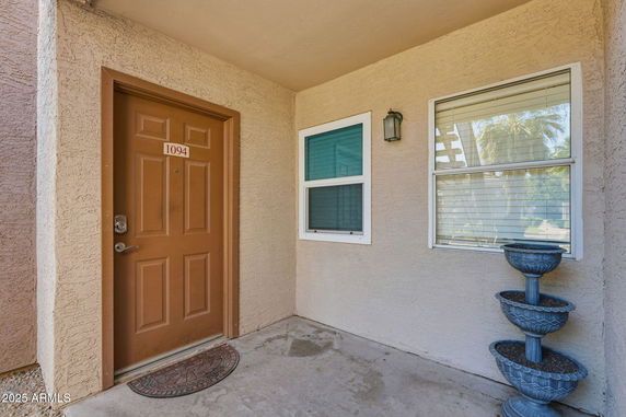 Front view of a building entrance with a brown door numbered 1094.