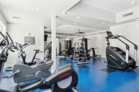 Interior view of a gym with exercise equipment and machines.