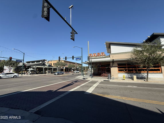 Front view of a commercial building labeled O.H.S.O Eatery & Brewery at a street intersection.