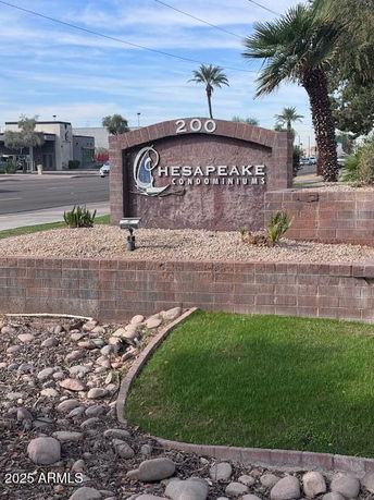 Front view of the entrance sign for Chesapeake Condominiums with landscaping.
