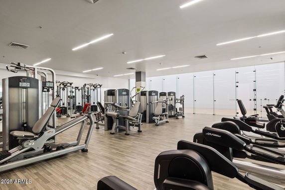 Indoor gym area with various exercise equipment and machines