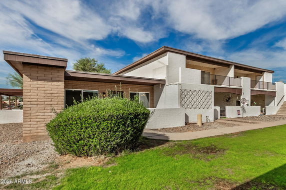 Front view of a two-story house with a modern design and balcony.