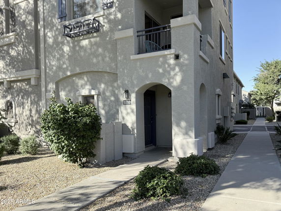 Front view of a multi-story residential building with balconies.
