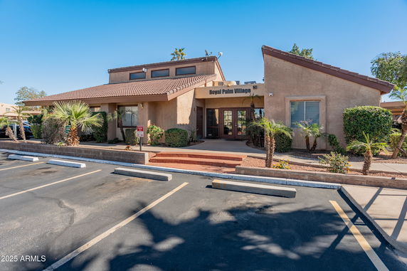 Front view of a single-story commercial building with a tiled roof and entrance stairs.