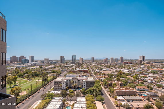 Panoramic view of a cityscape with multiple buildings and roads.