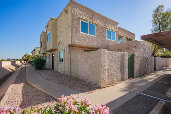 Front view of a two-story building with textured exterior walls and multiple windows.