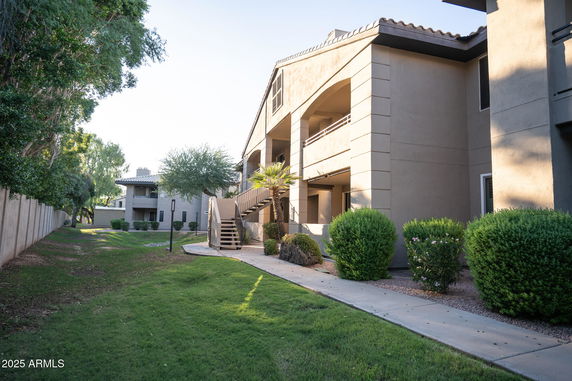 Front view of a two-story apartment building with visible staircases and balconies.