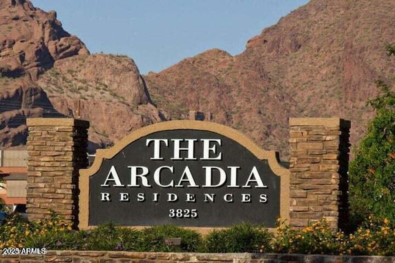 Signage in front of a residential complex named The Arcadia Residences.