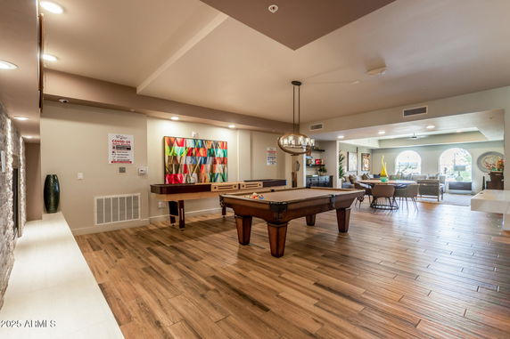 Room with a pool table and lounge seating area.