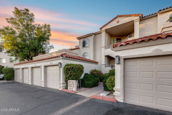 Front view of a multi-story building with multiple garages.