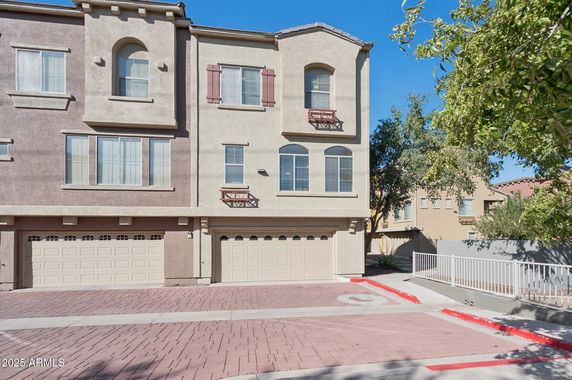 Front view of a two-story townhouse with a double garage.