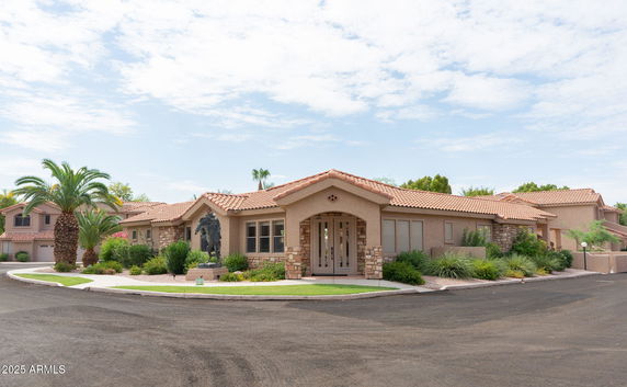 Front view of a single-story house with a tiled roof and stone accents.