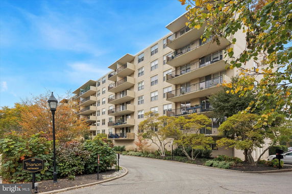 Front view of a multi-story apartment building with balconies.