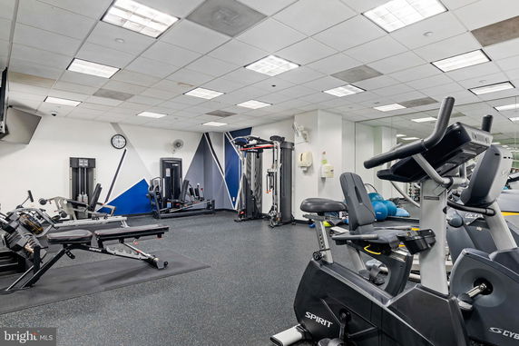 Interior view of a gym with exercise equipment and machines.