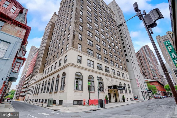 Front view of a multi-story building on a city street.