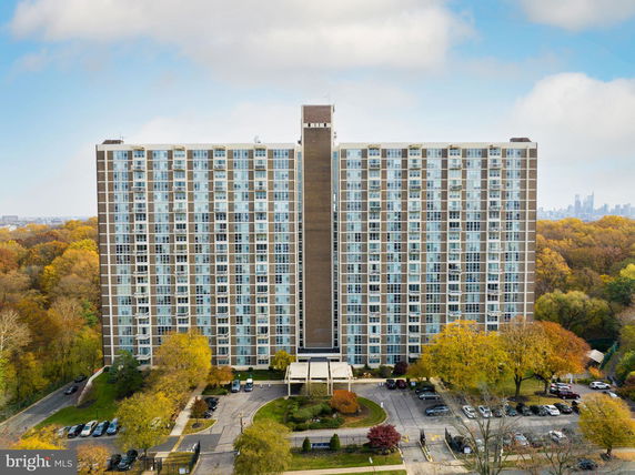 Front view of a high-rise building with multiple floors and large windows.