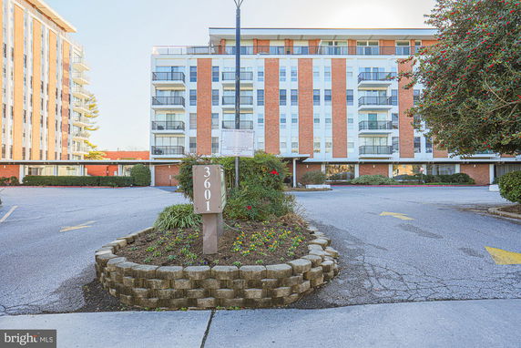 Front view of a multi-story building with balconies.