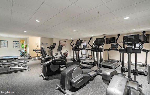 Indoor gym area with exercise machines and equipment.