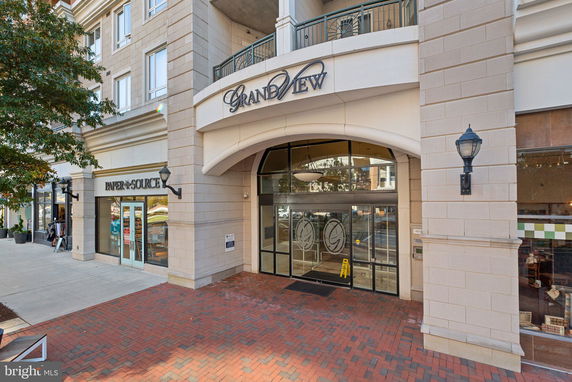 Front view of a multi-story building entrance with signage.