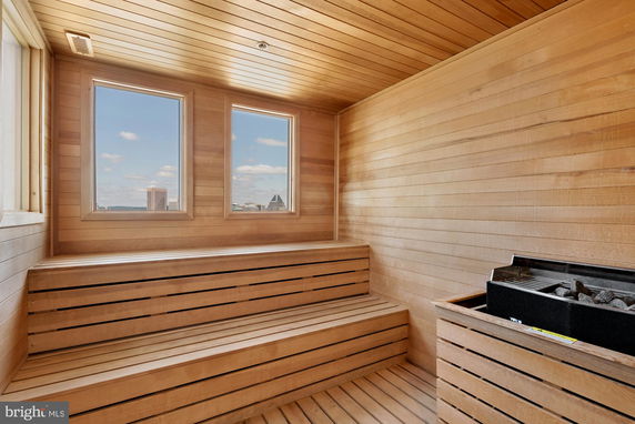 Interior view of a wooden sauna with a bench and heater.