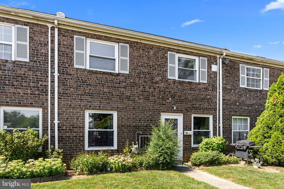 Front view of a two-story brick townhouse.