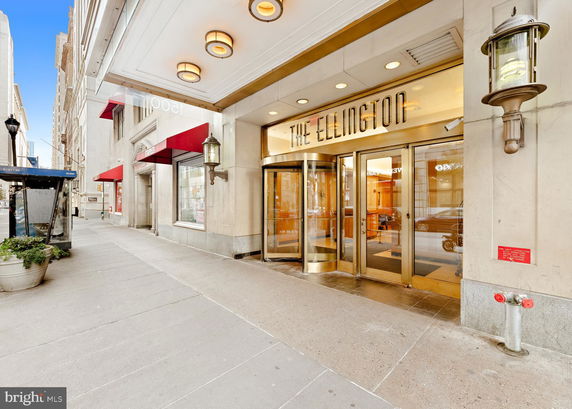 Entrance view of The Ellington building with a revolving door.