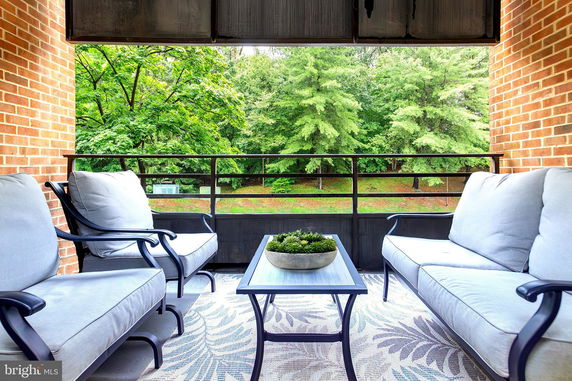 Outdoor seating area with a view of trees and greenery