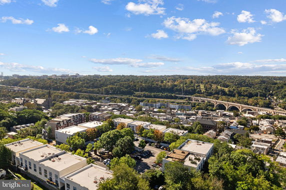 Panoramic view of a residential area with buildings and greenery.