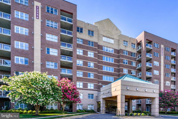 Front view of a multi-story residential building with balconies.