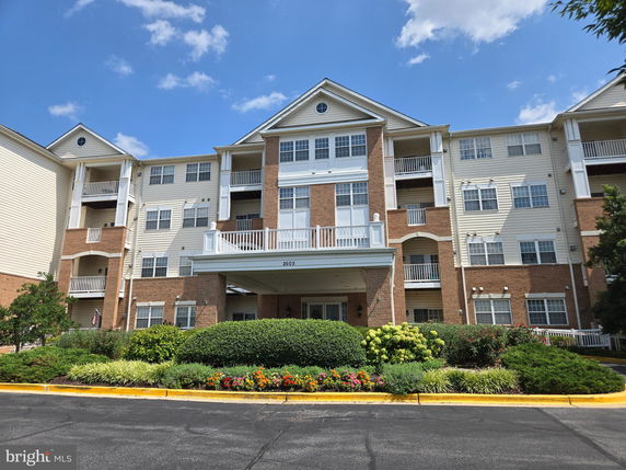 Front view of a multi-story residential building with balconies.