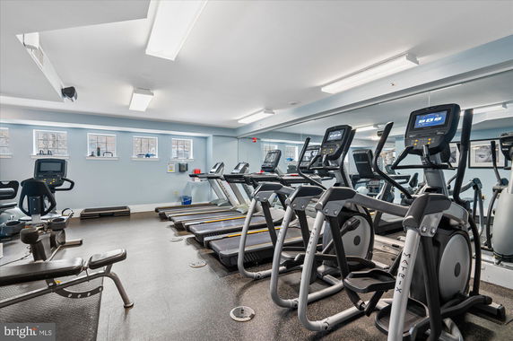 Interior view of a gym with treadmills and exercise equipment.