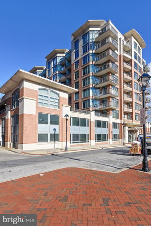Front view of a multi-story building with large windows and balconies.