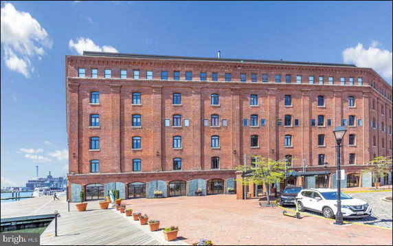 Front view of a multi-story brick building with multiple windows.