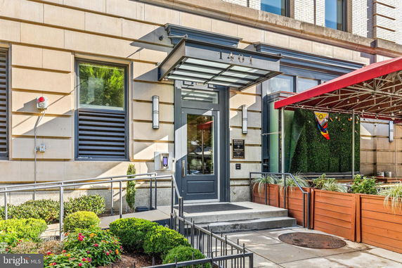 Front view of a building entrance with steps and a canopy.