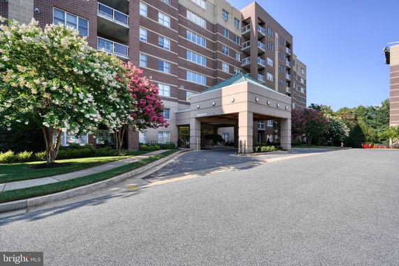 Front view of a multi-story building with a covered entrance.