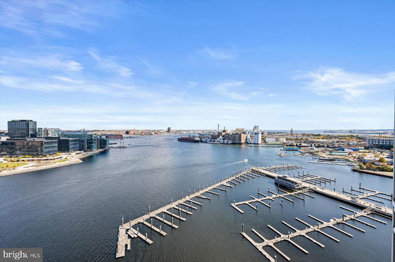 Panoramic view of a waterfront with docks and buildings.