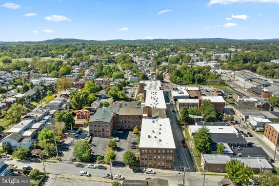 Aerial panoramic view of a town with residential and commercial buildings.