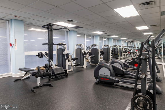Indoor gym area with various exercise machines and equipment.