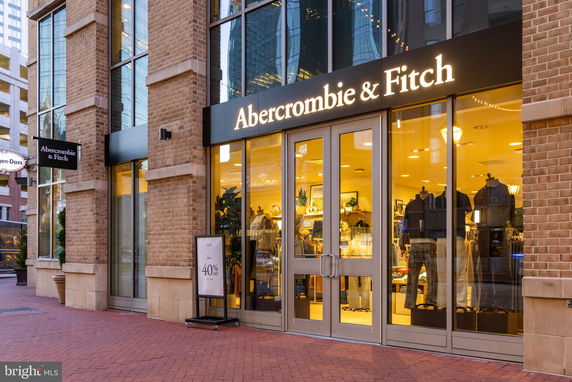 Front view of a retail store with large windows and brick facade.