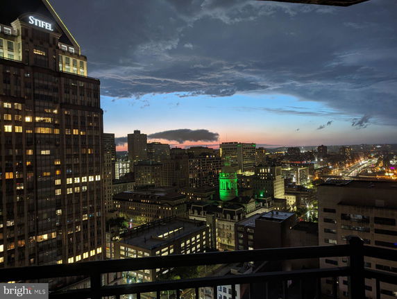 Panoramic view of city buildings and skyline at dusk.