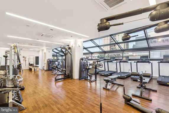Indoor gym area with exercise equipment and windows.
