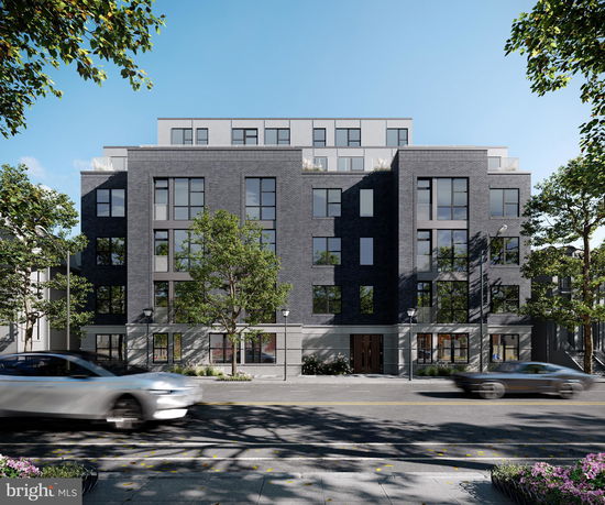 Front view of a multi-story apartment building with dark brick facade.